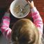 Little girl eating a bowl of Cheerios. Credit: Providence Doucet, Unsplash