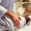Doctor patting a baby in a bassinet. Credit: Solen Feyissa, Unsplash