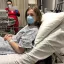 Teenager in a mask and gown in the hospital. Credit: HHE, Unsplash