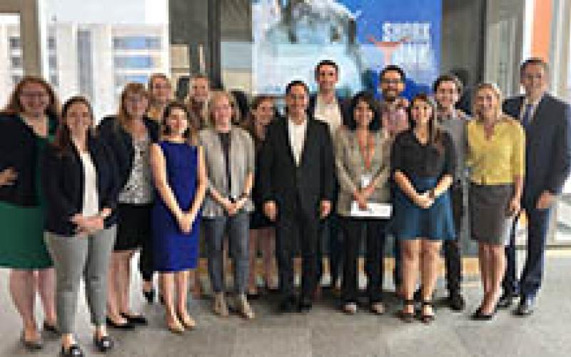 Students pose with former HUD Secretary Julian Castro (center) and Dr. Michael Hole (right)